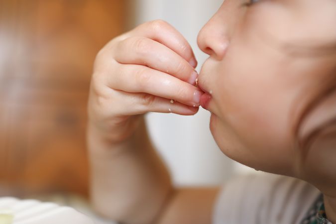 Close up shot of a kid learning how to eat healthy.