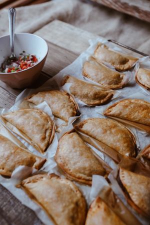 Baking tray with composed freshly baked pies patty