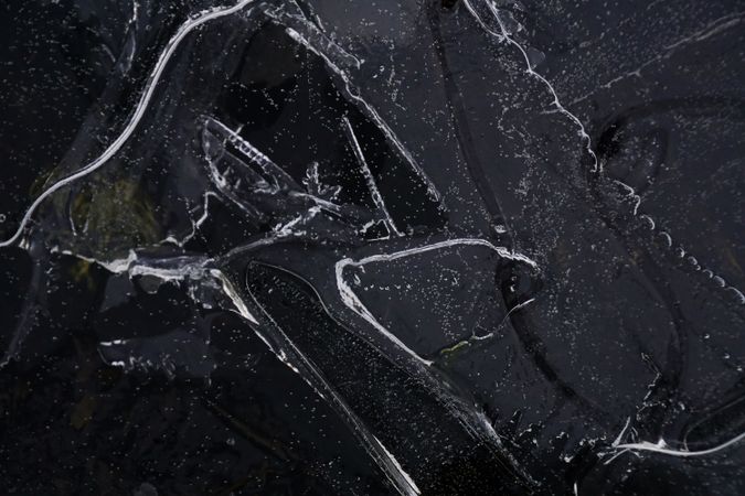 Fragment of thin ice on dark frozen river