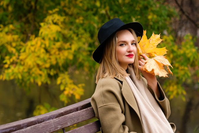 Woman on park bench in autumn