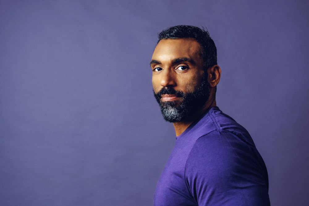 Proud male in purple studio, copy space