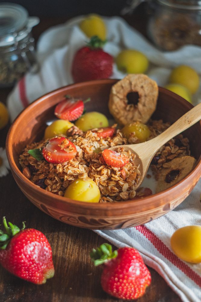 Cereal topped with berries, dried apple, and apricot