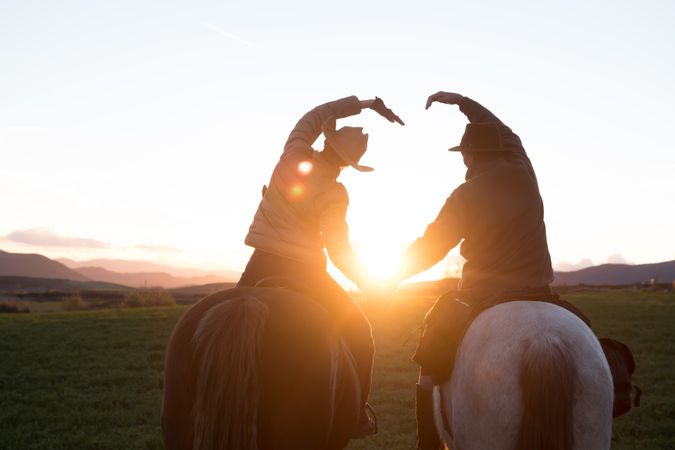 People on horses doing heart shape