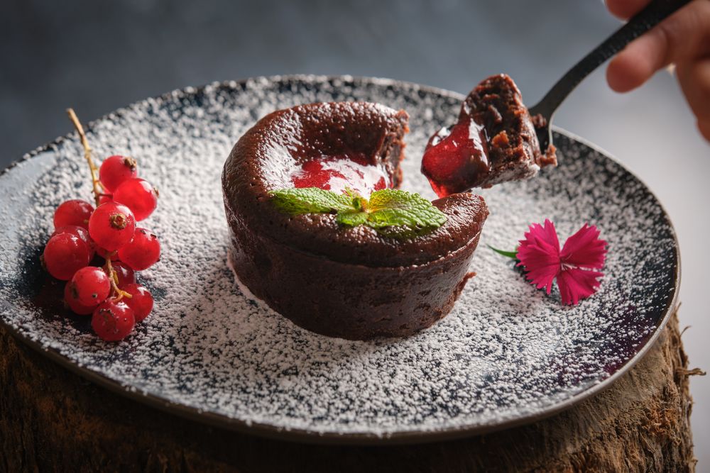 Anonymous person trying berry lava cake