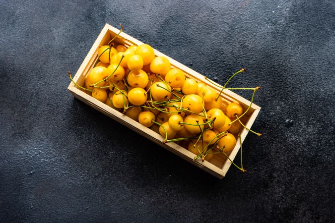 Carton of yellow cherries