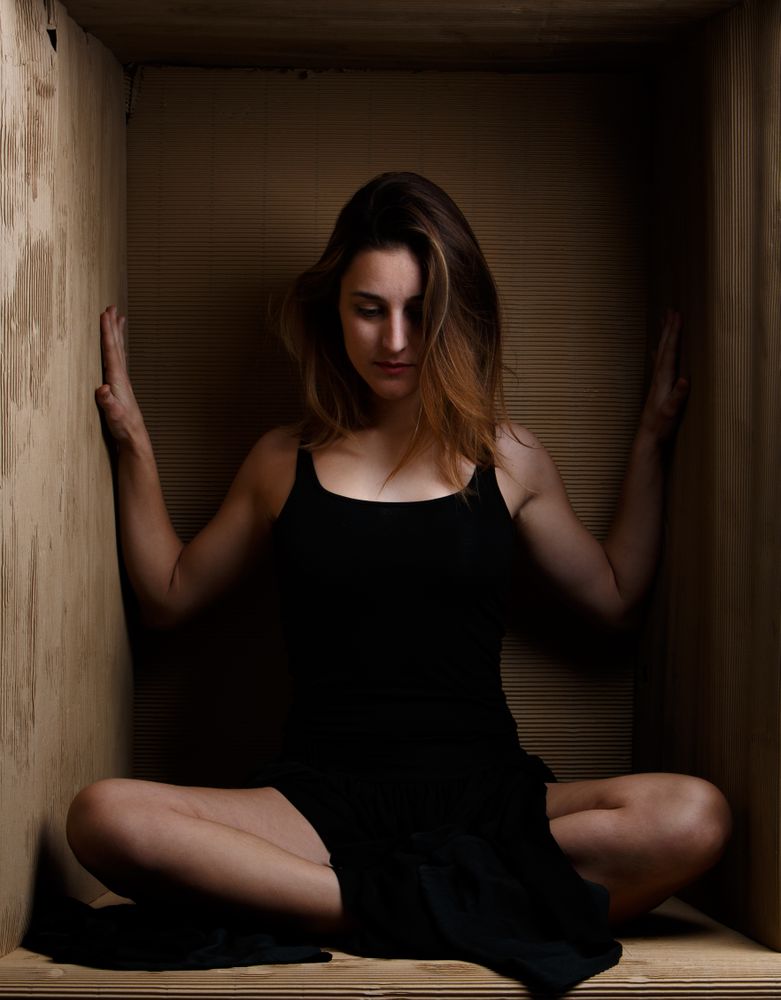 woman sitting in carton box