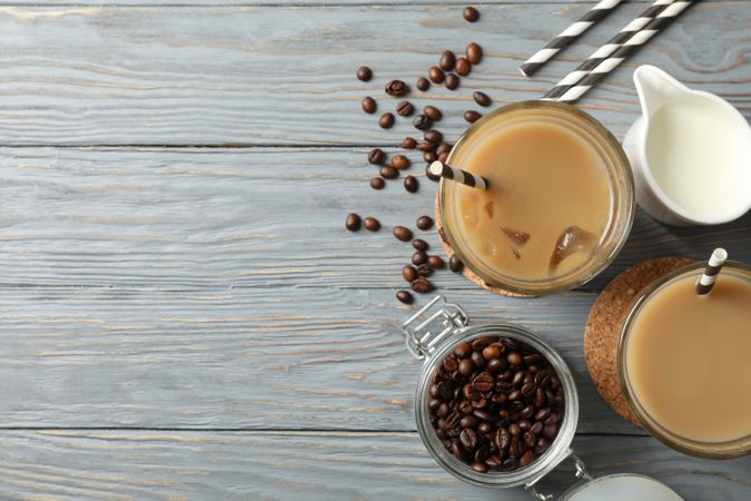 Composition with glasses of ice coffee on wooden background