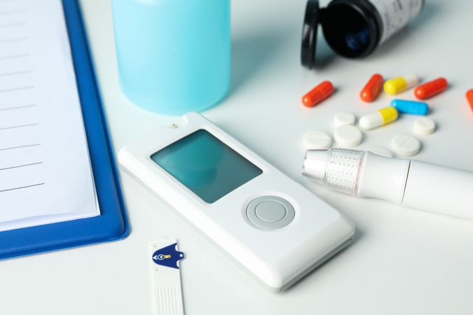 Diabetes accessories on blank background, close up