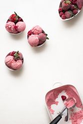 Frozen red berries and ice cream in bowls
