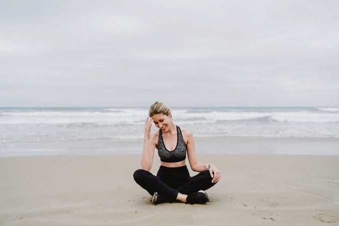 Woman meditating on the beach