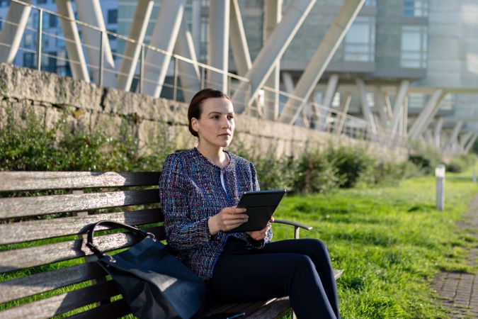 Businesswoman browsing tablet in park