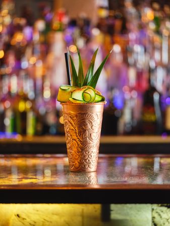 Fresh cocktail with cucumber and pineapple served on counter