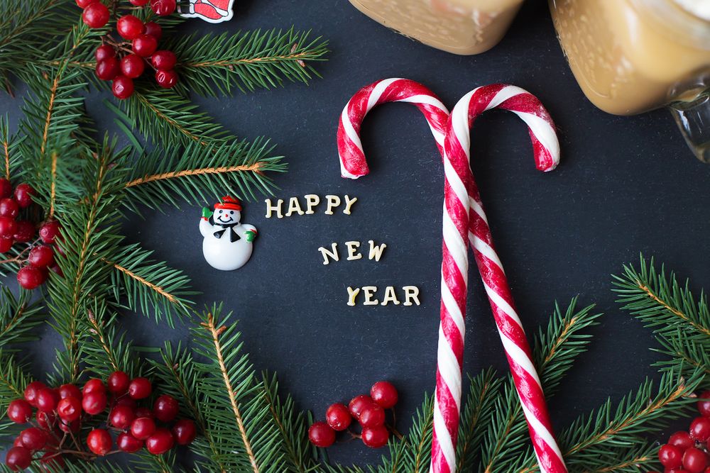 Christmas holiday background with hot cocoa and candy. The inscription Happy New Year