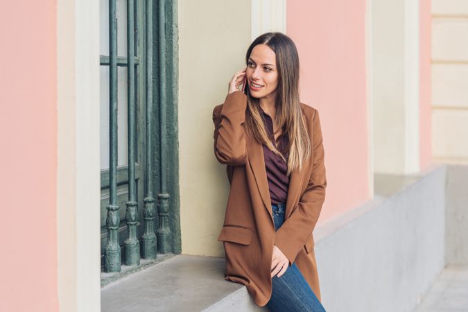 Pleased female in stylish outfit on street smiling away