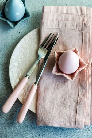 Festive Easter place setting decorated with pastel pink and blue eggs