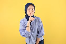Serious Young Asian Muslim Woman Showing Silence Gesture