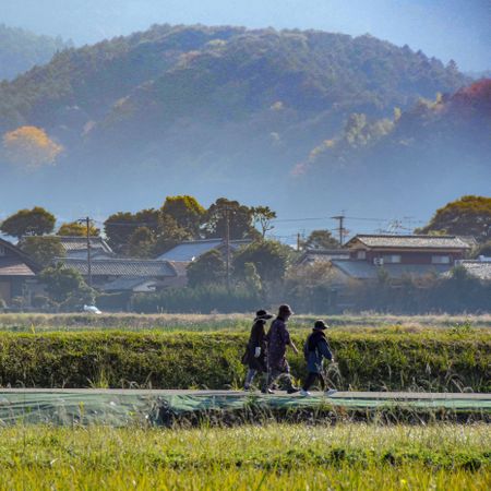 Group of people walking near mountainous landscape in Itoshima, Fukuoka, Japan