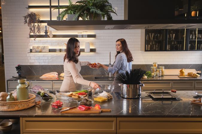 Female friends bonding while cooking together