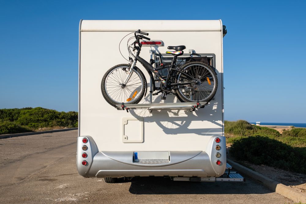 RV with bicycles on countryside road