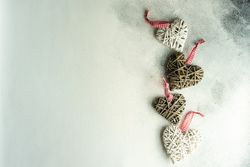 Top view of four heart shape decorations on marble surface