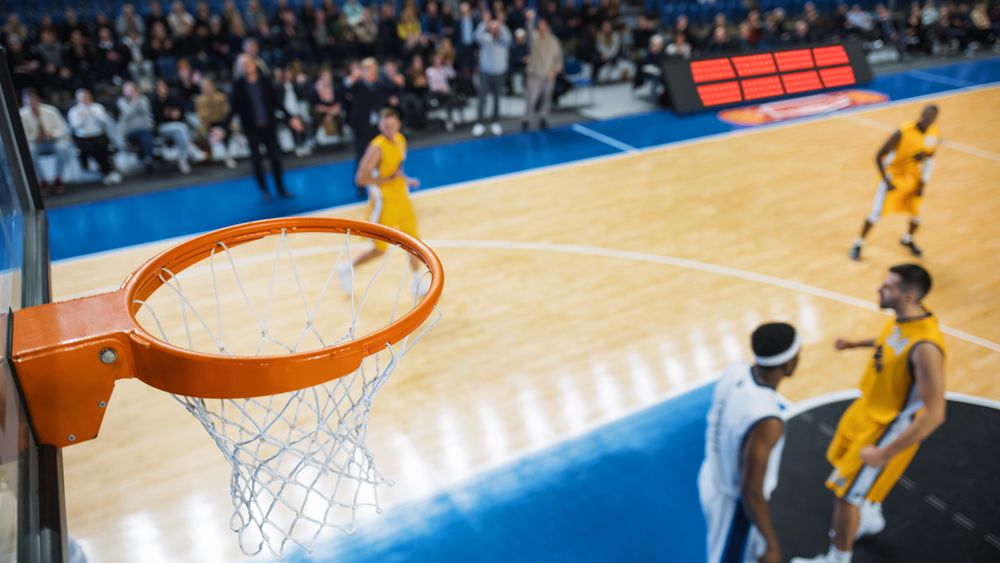 Basketball Tournament Final: Middle Of International Match With Basketballers Continuing Playing After Team Scored Goal.