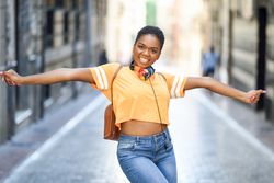 Female excitedly dancing in street