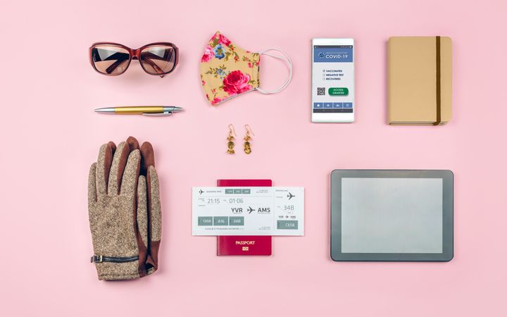 Set with mobile covid passport and businesswoman trip accessories