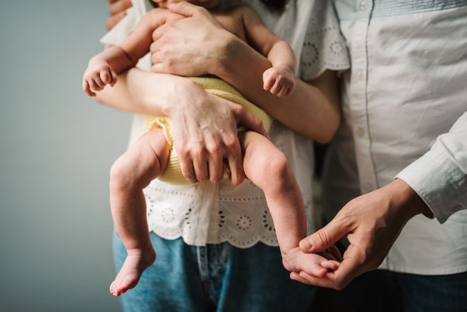 Crop parents comforting crying baby