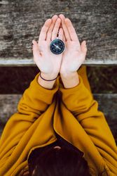 Crop woman with retro compass