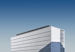 Long rectangular building on blue sky