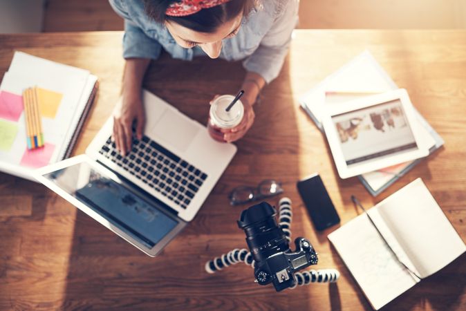 Top view of woman filming herself working on her laptop