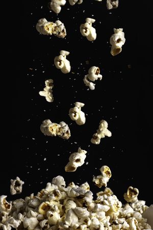 Popcorn falling down in dark background