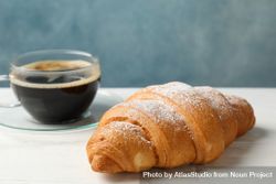 Croissants and cup of coffee in blue room 0J1mnb
