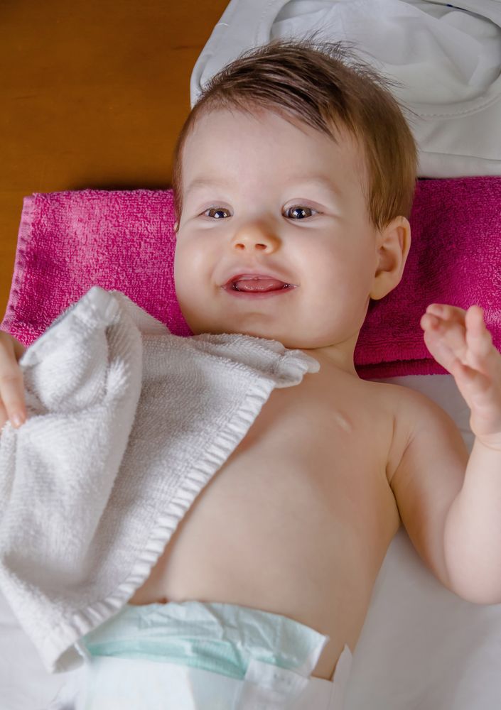 Face of cute baby having her diaper changed