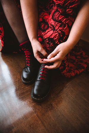 Woman in dress lacing boots