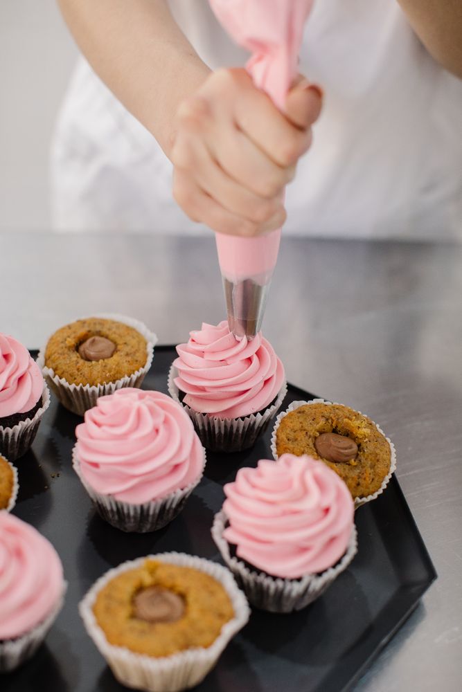 Chef making cupcakes with icing