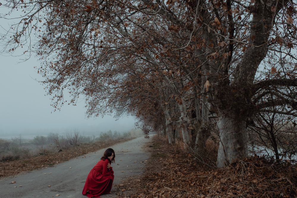 Woman in red dress in foggy area