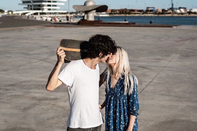 Trendy in love couple hugging on street