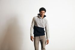 Man dressed in grey looking into camera