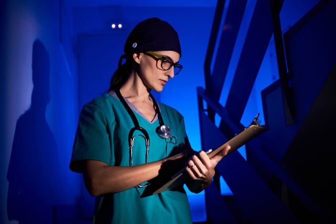Female doctor with tablet on staircase