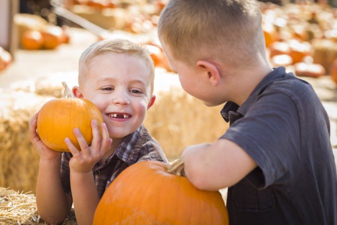 Two Boys at the Pumpkin Patch Talking and Having Fun.