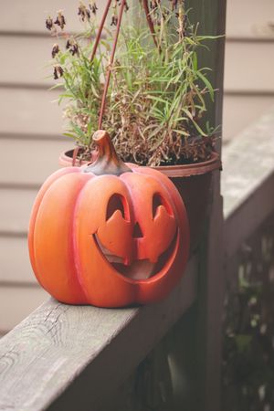Ceramic pumpkin decor on wooden plank for Halloween background