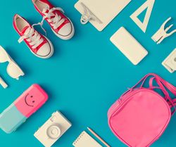 Back to school supplies on bright blue background
