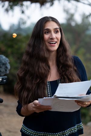 Female director looking up from script giving feedback