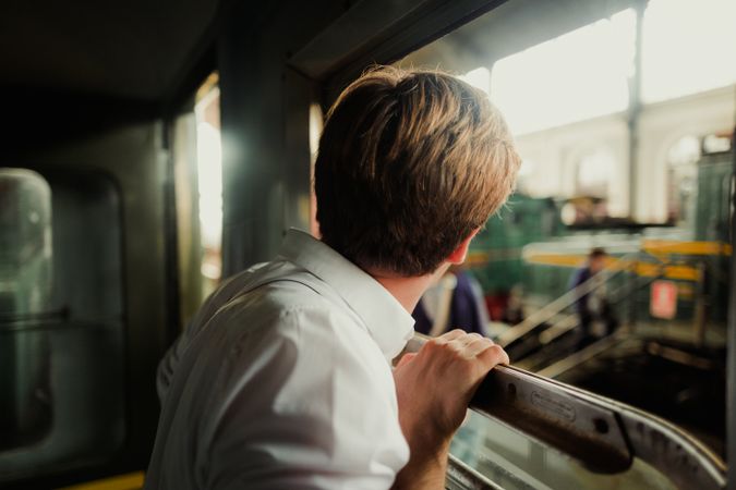 Traveler looking out train window