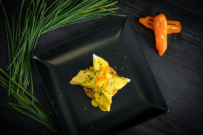 Corvina with yellow pepper sauce in plate
