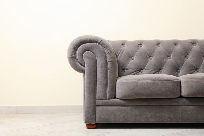 Simple interior with sofa against light beige wall