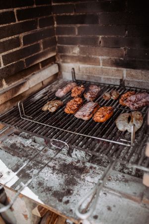 cooking sausages and chorizo in barbecue