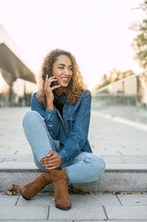 Smiling woman talking on smartphone