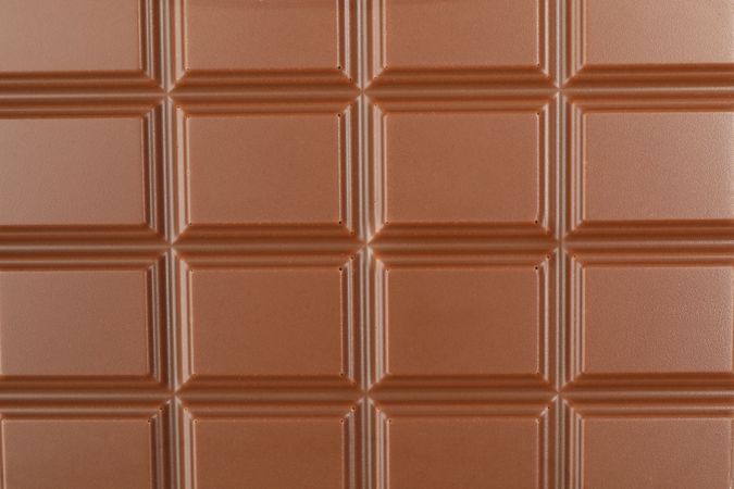 Different chocolate bars on whole background. Sweet food